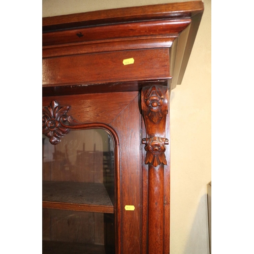 482 - A 19th century Continental carved mahogany bookcase, the upper section enclosed two arch top glazed ... 