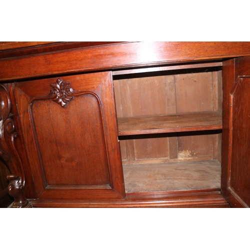 482 - A 19th century Continental carved mahogany bookcase, the upper section enclosed two arch top glazed ... 