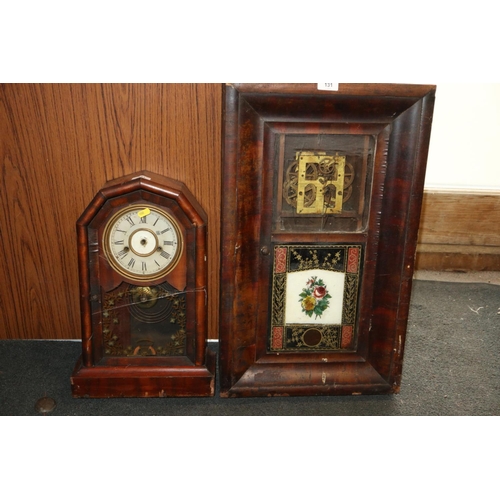 131 - A mahogany inlaid drop dial clock, and two similar clocks