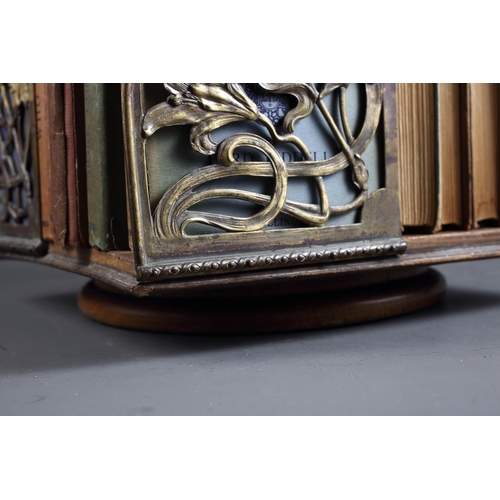 145 - An Art Nouveau oak and brass openwork table top bookstand and a number of John O'London vols, 12