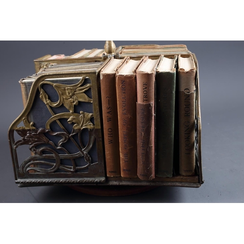 145 - An Art Nouveau oak and brass openwork table top bookstand and a number of John O'London vols, 12