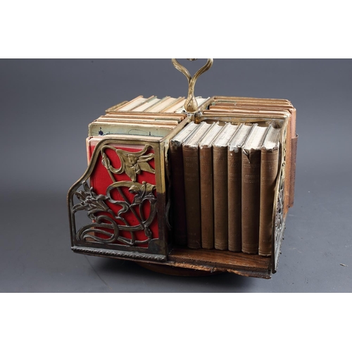 145 - An Art Nouveau oak and brass openwork table top bookstand and a number of John O'London vols, 12