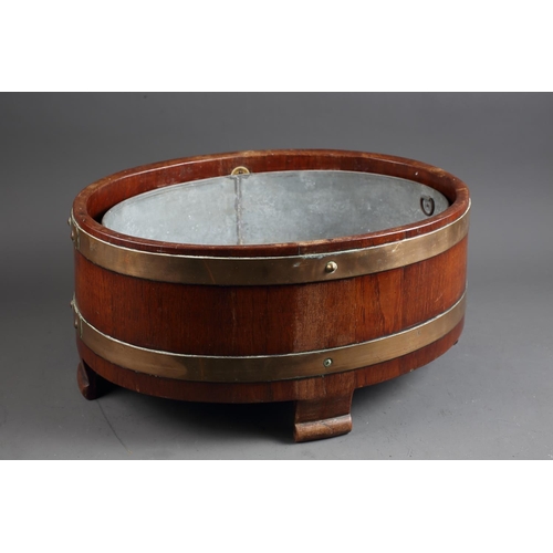 170 - An oak and brass coopered oval-shaped wine cooler/jardiniere, on four scrolled supports