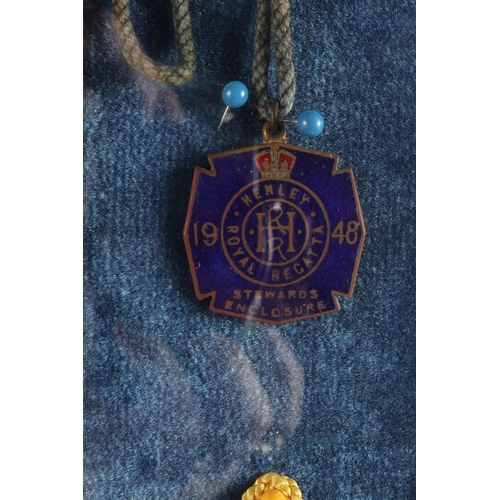 212 - Thirty nine Henley regatta badges, including a 1948 badge, in glazed display cabinet, 23