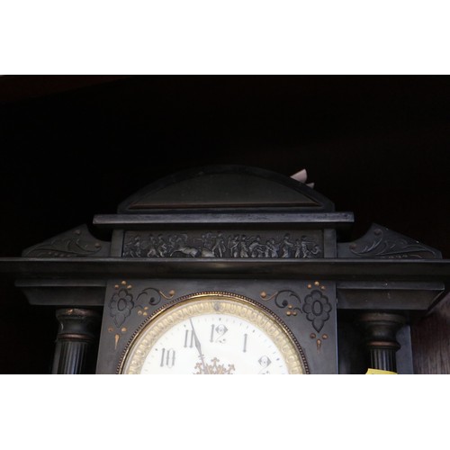 140 - A black marble arch top mantel clock with engraved decoration, enamelled dial and Arabic numerals, f... 