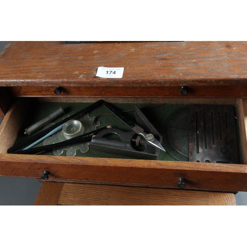 174 - An oak three-drawer toolbox and a collection of drawing instruments, rulers, etc