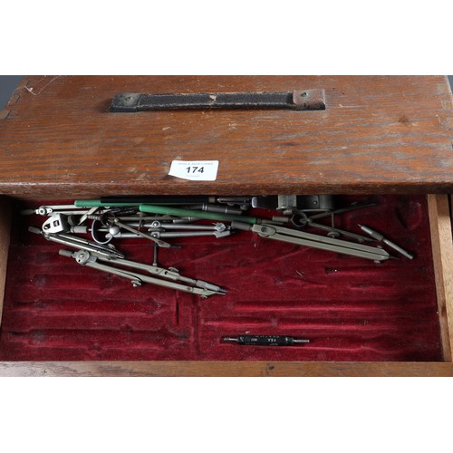 174 - An oak three-drawer toolbox and a collection of drawing instruments, rulers, etc