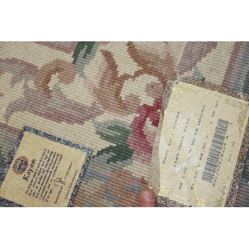 605 - A Chinese contour pile rug of traditional Aubusson design, in shades of green, rose, pink and grey o... 