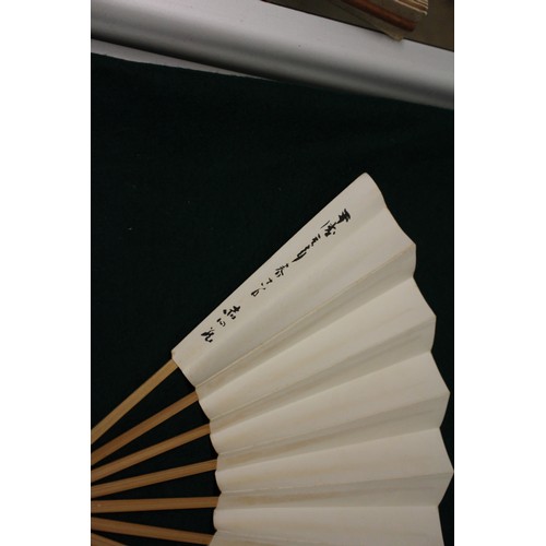 112 - Fifteen Japanese fans, some with calligraphy decoration, various