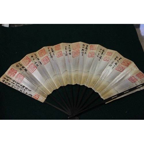 112 - Fifteen Japanese fans, some with calligraphy decoration, various