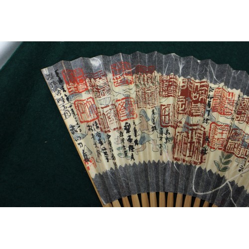 112 - Fifteen Japanese fans, some with calligraphy decoration, various