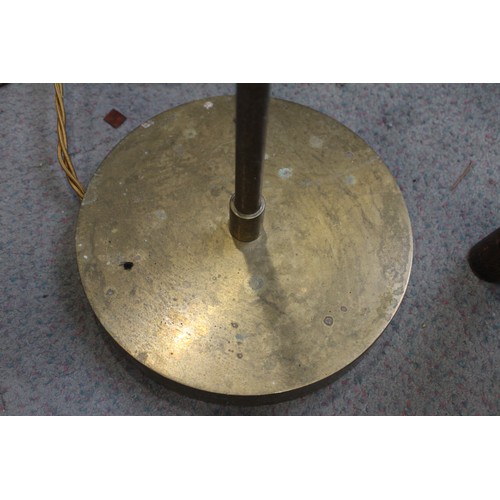 229 - A pair of brass adjustable floor standing reading lights, on circular bases, 45