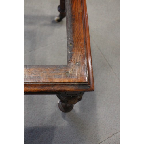 448 - A 19th century walnut low stool, on carved and turned castored supports, 38