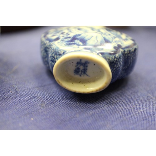 103 - Two Chinese blue and white tea bowls with panelled floral decoration and four-character, double ring... 