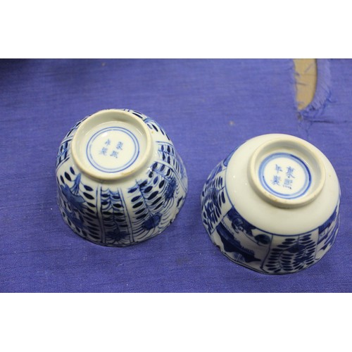 103 - Two Chinese blue and white tea bowls with panelled floral decoration and four-character, double ring... 