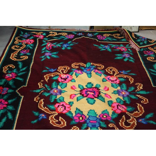 602 - A Kelim style carpet with all-over floral and scroll design and multi-borders in shades of red, plum... 