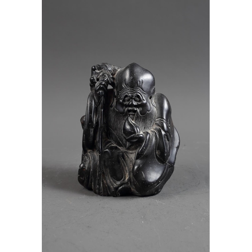 101 - A Chinese carved black hardstone figure, 6 1/4