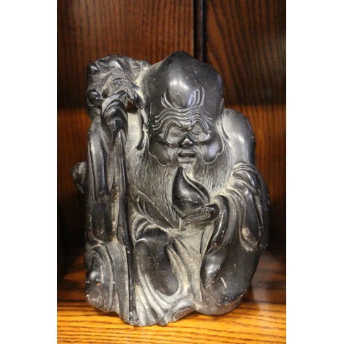 101 - A Chinese carved black hardstone figure, 6 1/4