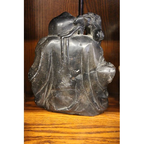 101 - A Chinese carved black hardstone figure, 6 1/4