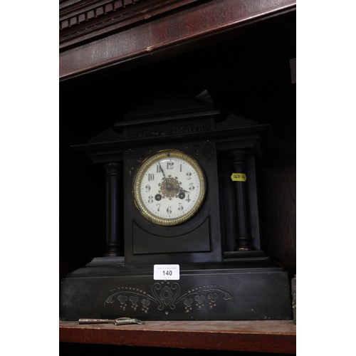 126 - A black marble arch top mantel clock with engraved decoration, enamelled dial and Arabic numerals, f... 