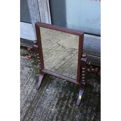 514 - An oak swing frame toilet mirror, on bobbin turned stand and splay supports, 18