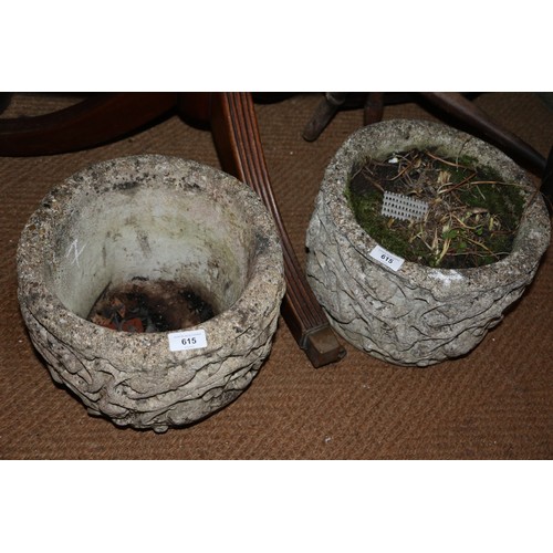 594 - A pair of cast stone planters with floral scroll decoration, 12