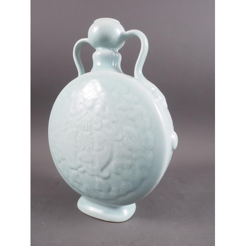 100 - A Chinese celadon glazed two-handled moon flask with pair of fish, character and cloud decoration, s... 