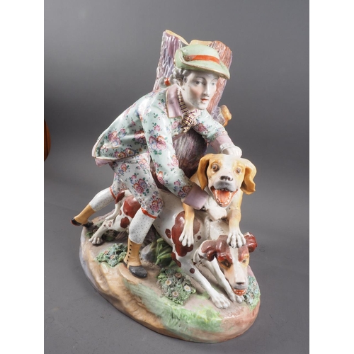 11 - A 19th century Meissen figure group of a hunter with two dogs by a tree, 14 1/2