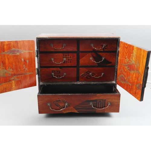 117 - A 19th century Japanese parquetry cabinet, fitted drawers and enclosed two doors, 11 3/4