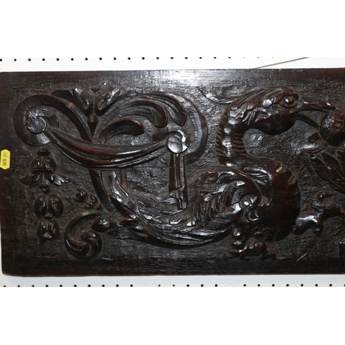 183 - A mid 17th century carved oak panel with phoenix, vase of fruit and scrolls, 11