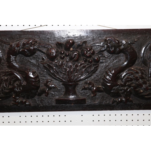 183 - A mid 17th century carved oak panel with phoenix, vase of fruit and scrolls, 11