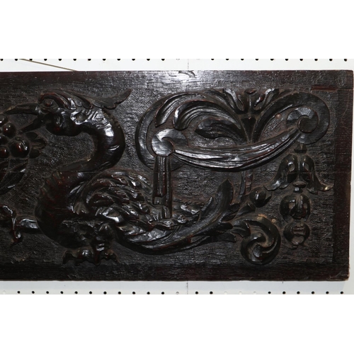 183 - A mid 17th century carved oak panel with phoenix, vase of fruit and scrolls, 11