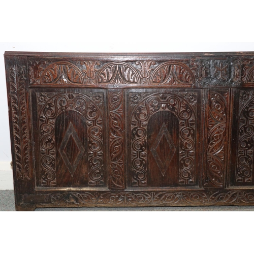 184 - An early 17th century carved oak four panel coffer front with arcade design, 58