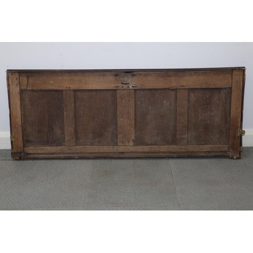 184 - An early 17th century carved oak four panel coffer front with arcade design, 58