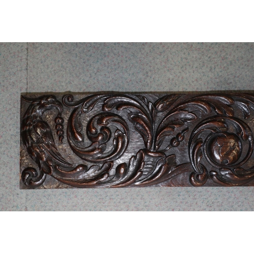 186 - A 17th century carved oak scrollwork panel with grapes, pomegranate and phoenix, 7 1/4