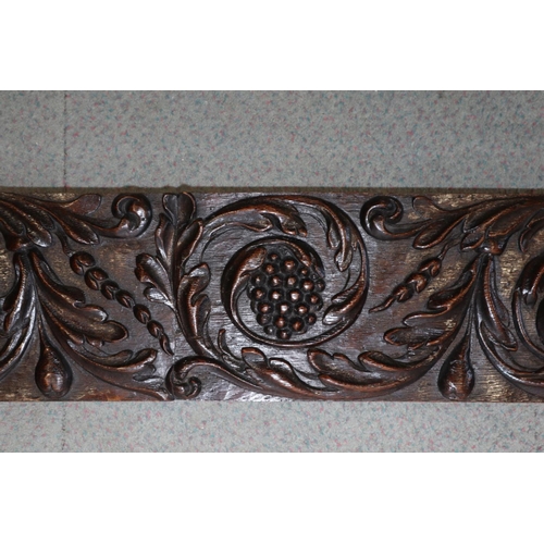 186 - A 17th century carved oak scrollwork panel with grapes, pomegranate and phoenix, 7 1/4