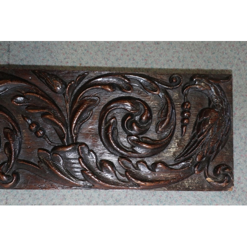 186 - A 17th century carved oak scrollwork panel with grapes, pomegranate and phoenix, 7 1/4