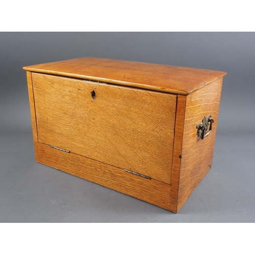 194 - An early 20th century oak stationery cabinet/writing box with fitted interior and fold out writing s... 