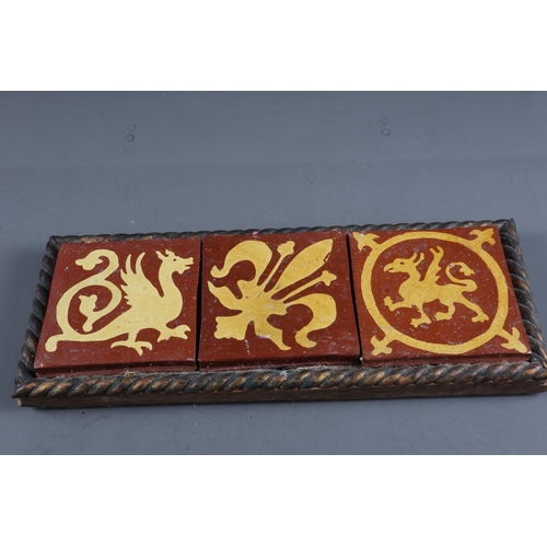 21 - A set of three encaustic tiles of Medieval design, in oak frame, and a 19th century Staffordshire ar... 