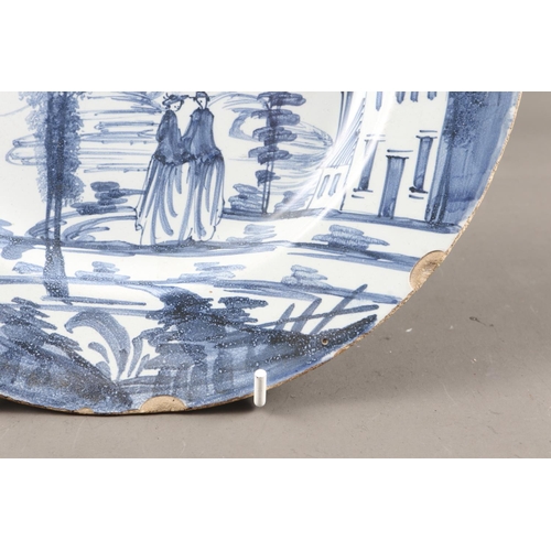 27 - An 18th century Bristol delft plate with landscape and figure decoration, 9