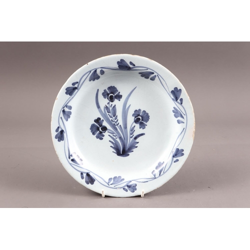 28 - An early 18th century Lambeth delft plate with floral spray, 9