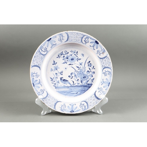 34 - An 18th century Lambeth? delft charger with garden and bird decoration, 13