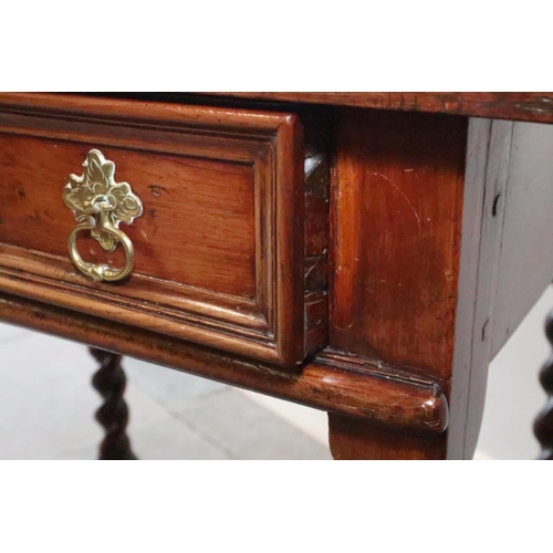 430 - An early 18th century yew side table, fitted one drawer with brass shaped drop handle, on bobbin tur... 