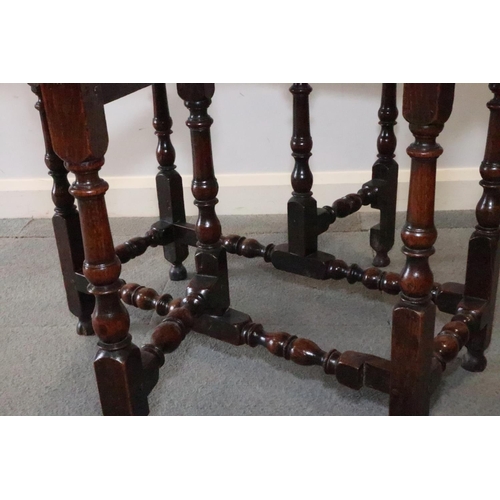 431 - A mid 18th century provincial oak gateleg dining table, on baluster turned and stretchered supports,... 