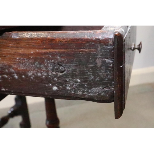 431 - A mid 18th century provincial oak gateleg dining table, on baluster turned and stretchered supports,... 