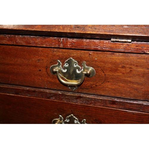 432 - An 18th century oak fall front bureau, the interior fitted drawers and pigeonholes over four long gr... 