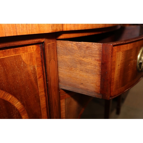 434 - A late Georgian mahogany and rosewood banded serpentine sideboard, fitted centre drawers and deep cu... 