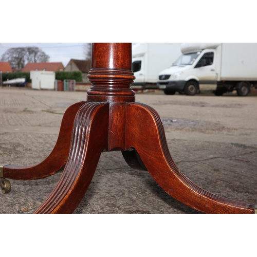 435 - A late Georgian mahogany double pedestal dining table with two extra leaves, on turned columns and t... 