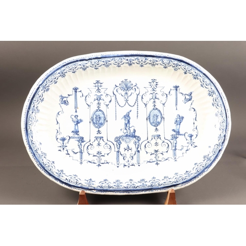 44 - An 18th century Moustiers faience oval charger/serving dish with Berain style Rococo scrollwork with... 