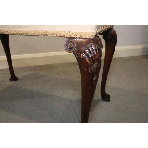 452 - A carved walnut stool of early Georgian design, on cabriole supports and scroll feet, 32